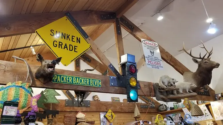 Vintage signs, a traffic light, and mounted elk inside the store